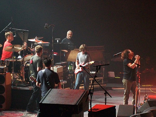 Pearl Jam and collaborator Boom Gaspar (keyboards) on the Backspacer Tour. Pictured in a semi-circle behind Eddie Vedder in this concert in Manchester