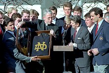 The 1988 national champion Fighting Irish visited President Ronald Reagan in the White House in January 1989. President Ronald Reagan hosting the NCAA football champion University of Notre Dame football team.jpg