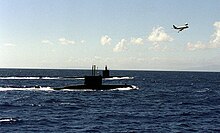 ROKS Lee Jongmoo (SS-066) and USS Columbus (SSN-762) off the coast of Hawaii; a United States Navy P-3 Orion can be seen observing them nearby. ROKS Lee Jongmoo.jpg