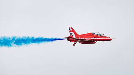 English: Red Arrows BAe Hawk T.1A (reg. XX177) with blue smoke at the Royal International Air Tattoo 2023.