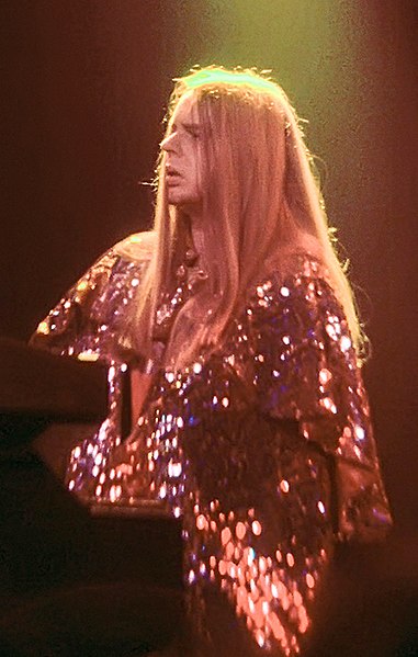 Wakeman performing with Yes in 1974. By this time, he had a distinctive look of long blonde hair and wearing capes on stage