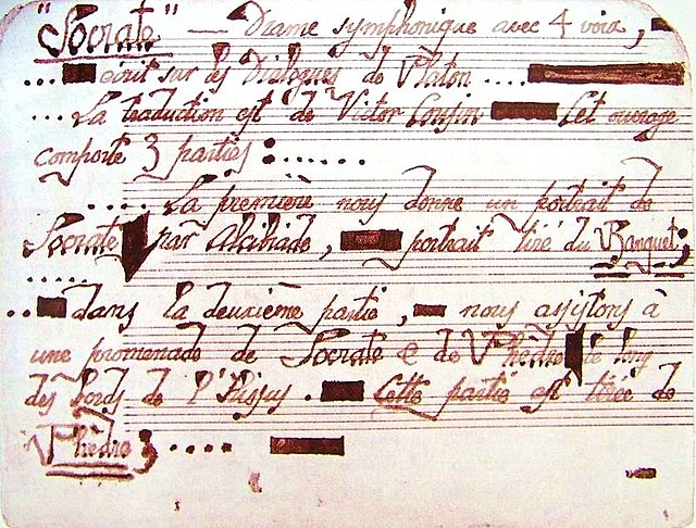 neatly written manuscript of musical score, with careful, calligraphic letters in red ink