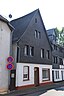 Cultural heritage monument at Steinweg 27 in Montabaur, Westerwald, Germany. Covered half-timered house from the 17th or 18th century. Seen from north