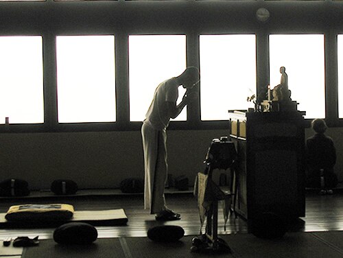 Buddhist offering incense to an image