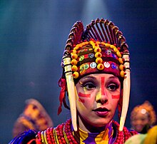 A dancer during a performance of Festival of the Lion King at Disney's Animal Kingdom. Tusk Woman at Festival of the Lion King.jpg