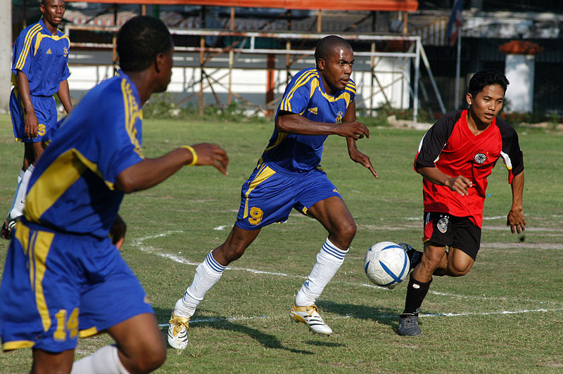 File:US Navy 060227-N-1693W-039 Boatswain's Mate 3rd Class Godfrey Bamfield runs the soccer ball downfield during a friendly soccer match.jpg