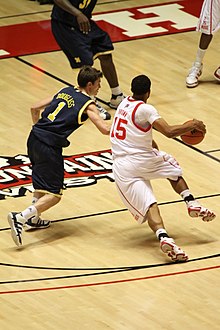 Brown (#15) driving to the basket playing against Michigan at home in December 2009 20091209 Stu Douglass defending.jpg