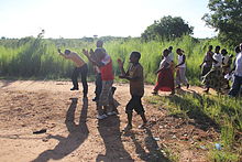 Villagers making a transect walk or 'walk of shame' to the open defecation places, singing 'let us end open defecation' (village near Lake Malawi, Malawi) Actions to end open defecation in a village in Malawi (3).jpg