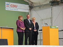 From left to right: Angela Merkel, Jost de Jager, and Susanne Herold at a campaign event in Flensburg. Angela Merkel und Jost de Jager sowie Susanne Herold in Flensburg zur Landtagswahl in Schleswig-Holstein 2012.JPG