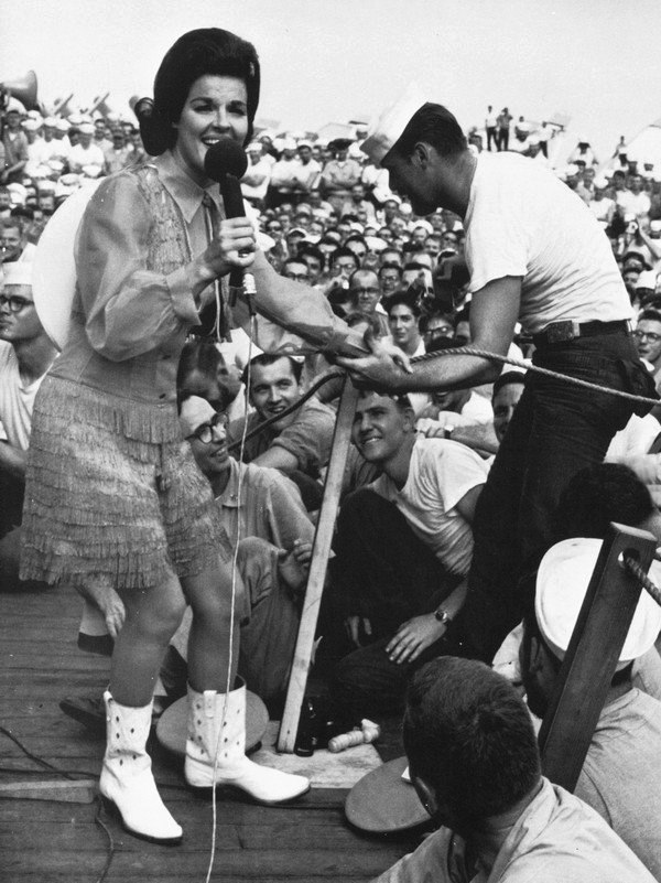 Anita Bryant with a sailor during a Bob Hope USO show on the USS Ticonderoga in 1965