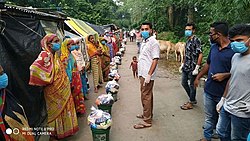 Ashraful Distributing Flood Refief.jpg