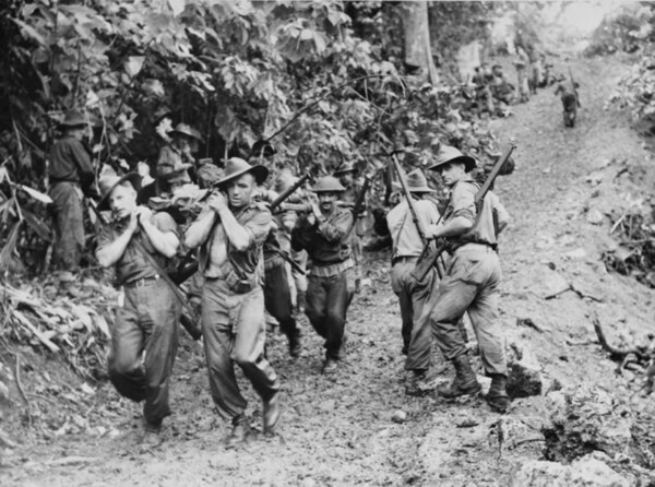 Soldiers from the 29th/46th Battalion evacuate a wounded comrade following fighting around Gusika on New Guinea, November 1943