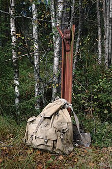 Backpack used by Jewish refugees, placed at remnants of gate at a border crossing to Sweden Backpack from WWII at border bw Sweden and Norway.jpg