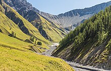 Photographie couleur d'une vallée montagnarde.