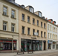 Residential and commercial building in closed development, with remains of the original shop front