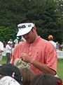 Bubba Watson signing autographs on the putting green of the Congressional Country Club during the Earl Woods Memorial Pro-Am prior to the 2007 AT&T National tournament.