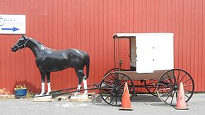 White topped buggy of the Nebraska Amish with a model horse on Main Street Buggy model horse Belleville PA.jpg