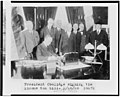 Calvin Coolidge signing the income tax bill, also known as the Mellon tax bill. Secretary of the Treasury Andrew Mellon is the third figure from the right, and Director of the Budget, LCCN94505220.jpg