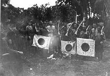 Solomon Islander scouts display Japanese weapons and flags captured during Carlson's patrol CarlsonsPatrolNativeTrophies.jpg