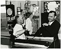 Dr. Roy W. Wampler of the Libbey-Owens-Ford Glass Company polishing one of the cover plates of the glass and metal assembly of the enclosure housing the Declaration of Independence. Dr. Luther H. Evans, Librarian of Congress, watches. The glass plates of the enclosures were made of special tempered glass and soldered to a lead strip sealing the documents into an airtight envelope.