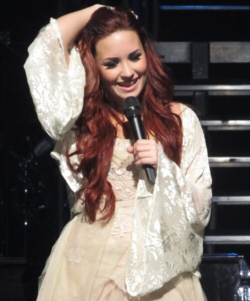 Lovato performing during her concert tour A Special Night with Demi Lovato in December 2011.