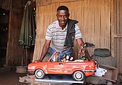 Didier Ahadsi with a BMW Cabrio in his atelier in Togo 2019