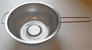 Colander bowl-shaped kitchen utensil with holes in it used for draining food