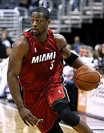 MDwyane Wade is driving to the basketball in an NBA game for the Miami Heat.