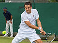 Evgeny Donskoy competing in the second round of the 2015 Wimbledon Qualifying Tournament at the Bank of England Sports Grounds in Roehampton, England. The winners of three rounds of competition qualify for the main draw of Wimbledon the following week.