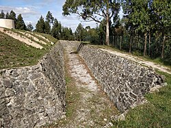 View of the stone-lined moat. The windmill originally on the site can be seen top left FortOlheiros2.jpg