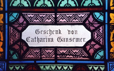 Stained glass panel at Saints Peter and Paul Church. Was donated by Catharina Gansemer (1824–1904), an early parishioner. "Geschenk von" means "gift o