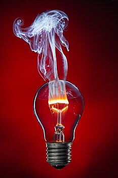 #1: The tungsten filament burning with a flame in the light bulb. - Attribution: Stefan Krause, Germany (License: FAL 1.3)