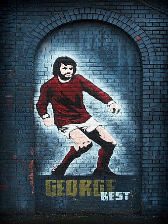 Mural of George Best in Belfast in his dribbling pose.