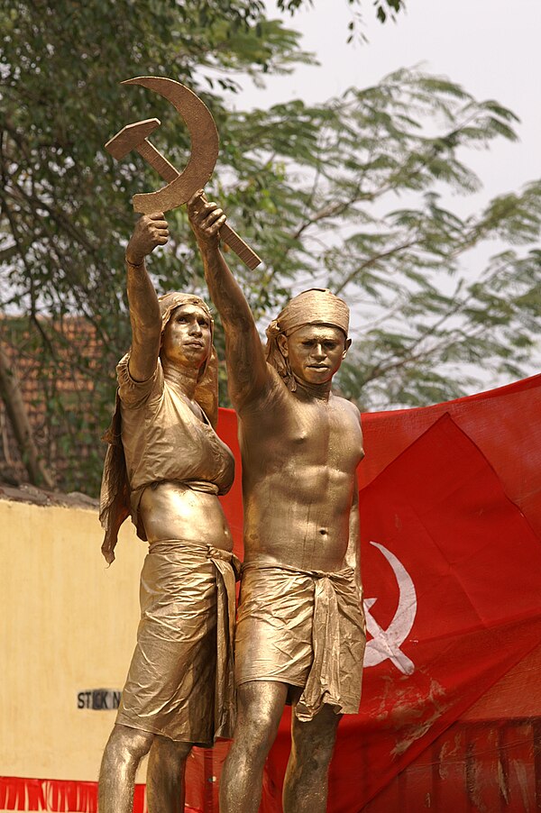 A tableau in a CPI(M) rally in Kerala, India showing two farmers forming the hammer and sickle.