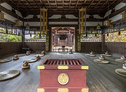 Interior view of the Buddhist temple Hounen Jonin Gobyo with red wooden chest and round straw carpets Chion-in Kyoto Japan