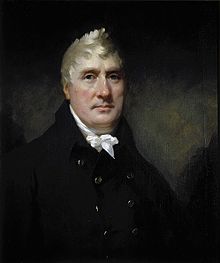 Portrait of male with white hair wearing a white cravat and blue jacket.