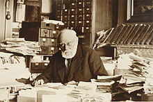Paul Otlet, working in an office built at his home following the closure of the Palais Mondial, in June 1937 Paul Otlet a son bureau.jpg