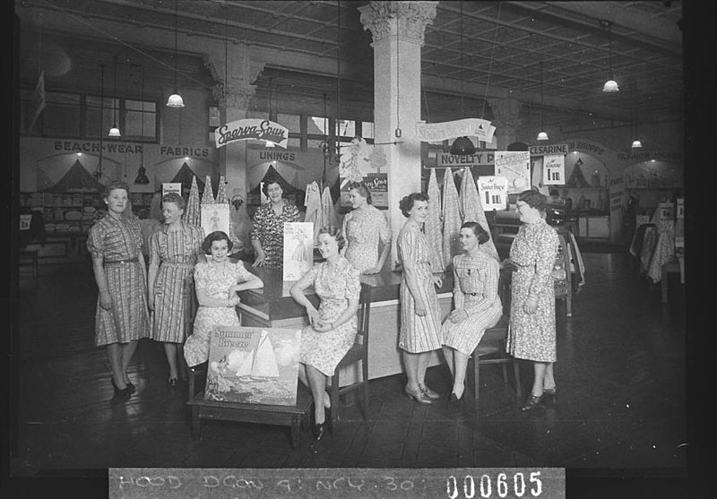 File:SLNSW 12423 Nine salesgirls in front of Cesarine fabrics and SparvaSpun Lining.jpg