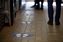 Floor markings can help people maintain distance in public places, especially when queueing.