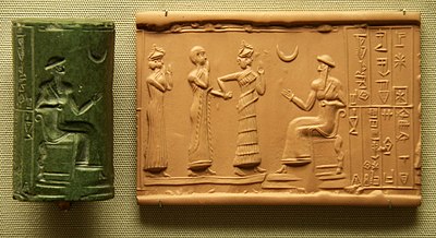 Sumerian cylinder seal and impression, dated c. 2100 BC, of Ḫašḫamer, ensi (governor) of Iškun-Sin c. 2100 BC. The seated figure is probably king Ur-Nammu, bestowing the governorship on Ḫašḫamer, who is led before him by Lamma (protective goddess).[295]