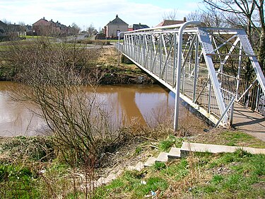 The site of the Tanzie Well beside the River Irvine. Tanzie Well and footbridge, Irvine.JPG