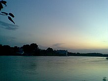 Wooded riverbank at twilight