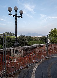 Trash and temporary fencing on Via Cesario Console, with Vesuvius on the background, Naples, Italy