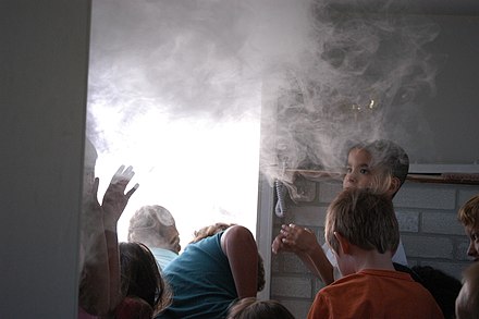 Children evacuating a smoky building as a way to learn fire safety