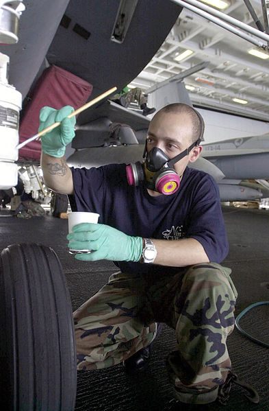 File:US Navy 030716-N-0413R-008 Aviation Structural Mechanic 3rd Class Ivan Irizarry of Harlem, N.Y., applies a coat of paint to the nose landing gear of an aircraft, in the Hanger Bay aboard USS Nimitz (CVN 68).jpg