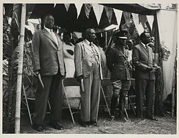 Four kings of Ugandan kingdoms, from left to right: The Omugabe of Ankole, Omukama of Bunyoro, the Kabaka of Buganda, and the Won Nyaci of Lango, at the signing of an agreement in Kabarole, Toro, Uganda, between the British governor, Sir Frederick Crawford  and the Omukama of Toro.