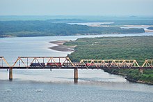 The Tumen River flows into the Sea of Japan. The last 17 km of the river form the border between North Korea and Russia. This picture is of the Korea Russia Friendship Bridge that crosses the Tumen River. Guo Ji Ke Yun Lie Che Zai Tu Men Jiang Tie Lu Qiao Shang Xing Shi ,Chi Kai Zhao Xian Jin Ru E Luo Si  - panoramio.jpg