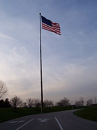 Acuity flagpole, 2006-2008 on the south side of Acuity's corporate campus. The current flagpole is placed on the north side of the campus near an artificial lake. AcuityInsuranceFlag.jpg