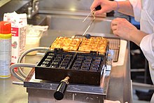 Cast-iron waffle iron, an example of cast-iron cookware Belgian waffles cooked in a Krampouz cast-iron waffle iron.JPG