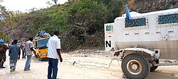 MONUSCO vehicle towing out a local bus in 2022